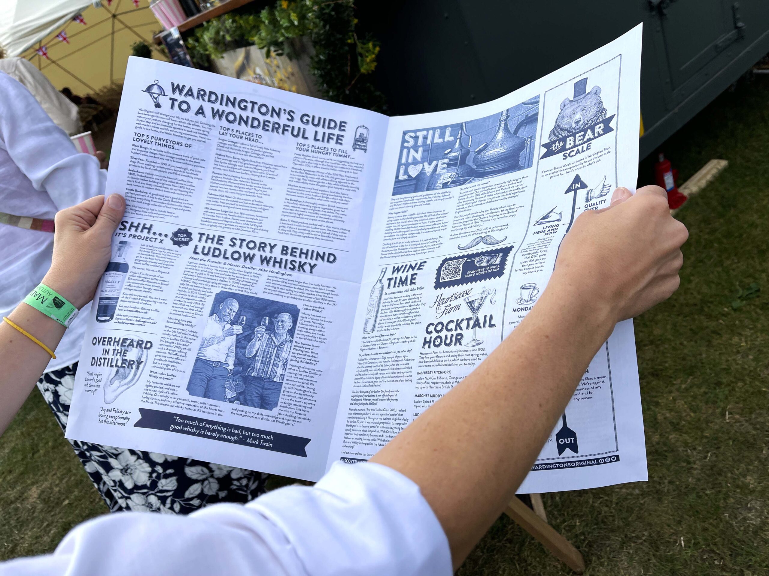 Wardington's Original The Gindependent centrefold of the newspaper being read by festival goers at Malvern Food Festival